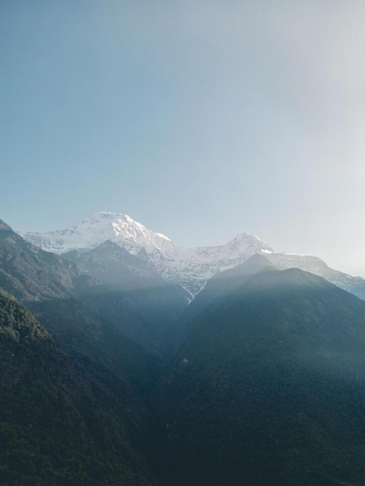 clouds over the mountains, mountains in the fog, during annapurna base camp, ghandruk, nepal photo