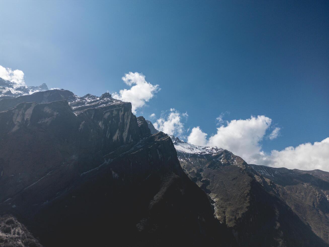 clouds over the mountains, mountains in the fog, during annapurna, annapurna base camp nepal photo