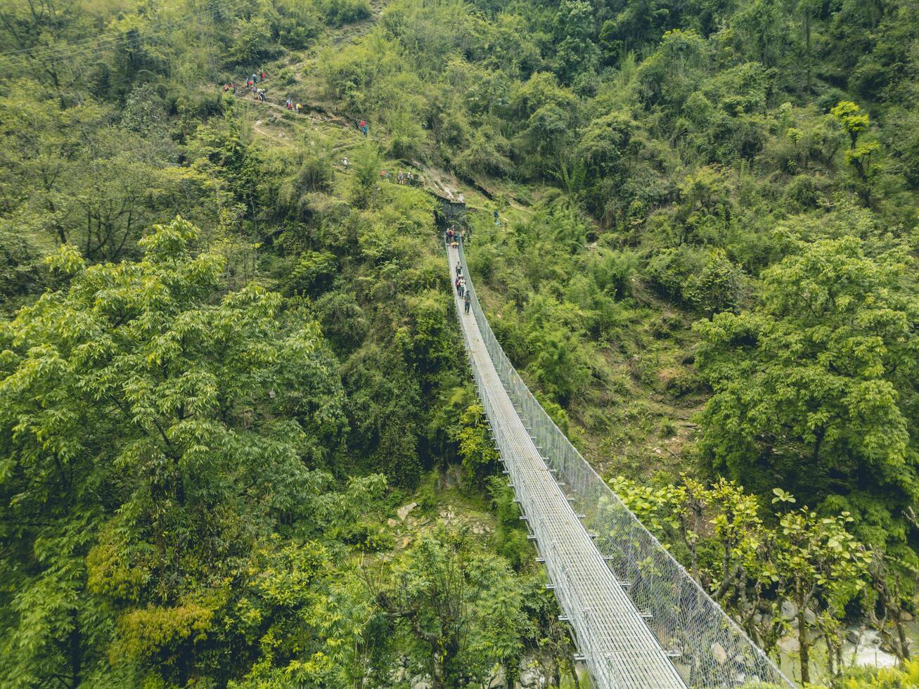 suspension bridge over the river, bridge over the mountain river, suspension bridge in ABC nepal photo