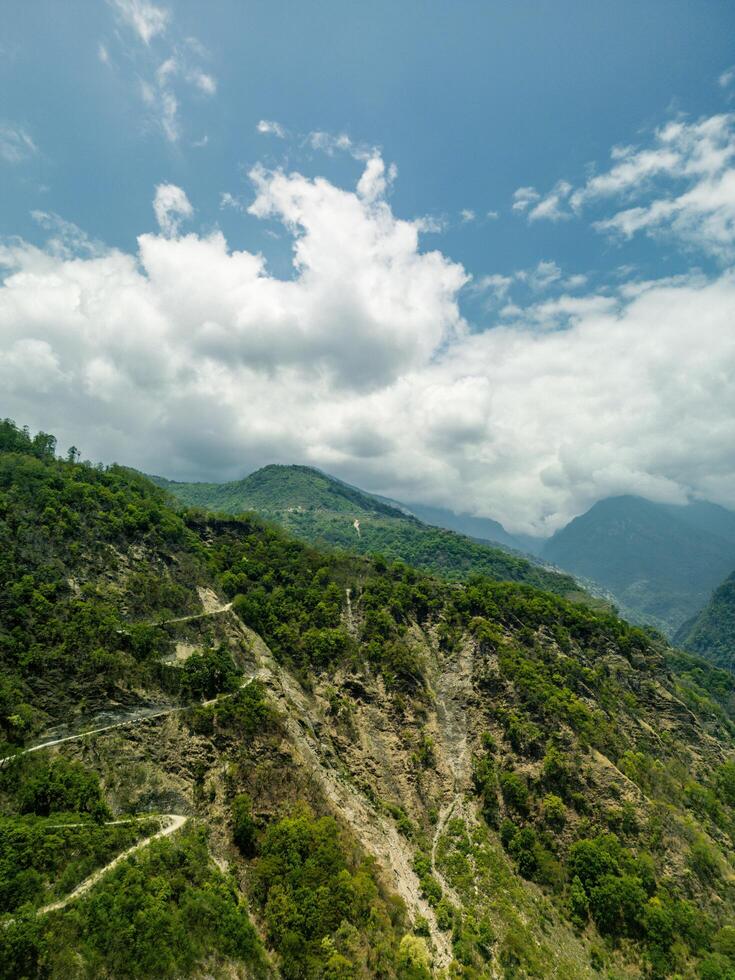 clouds over the mountains, mountains in the fog, during annapurna base camp, ghandruk, nepal photo