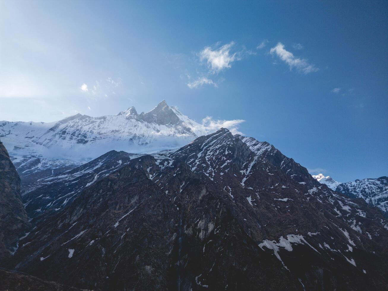 clouds over the mountains, mountains in the fog, during annapurna, annapurna base camp nepal photo