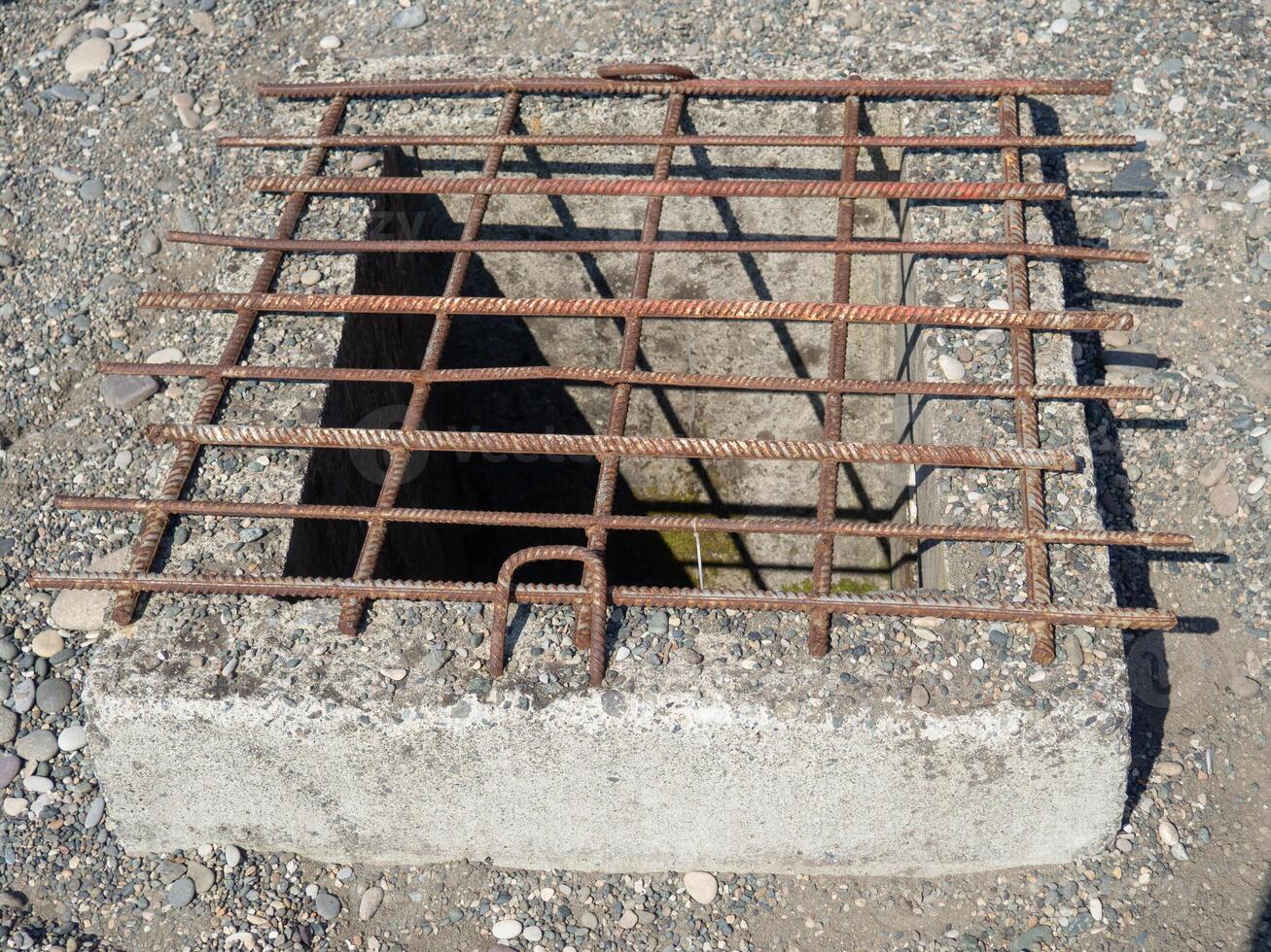 Barred underground entrance. Sewer entrance. photo