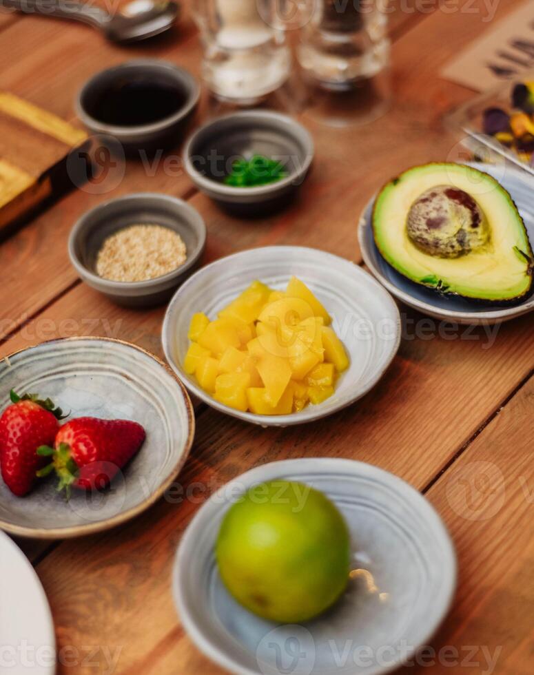 still life of avocado, peach and strawberries photo
