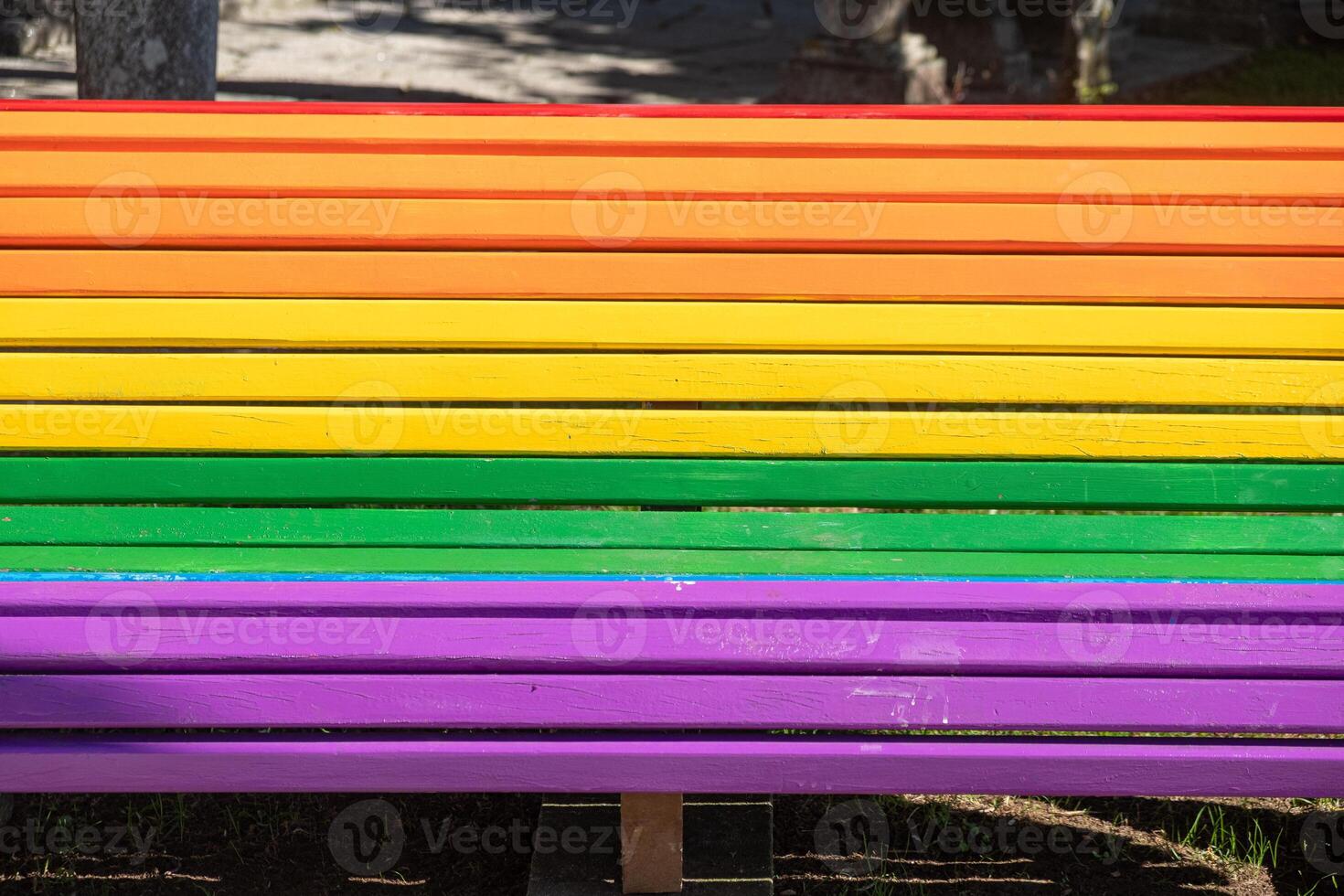 Detailed close up view LGBTQ rainbow painted bench in a park on as a support of LGBTIQ community photo