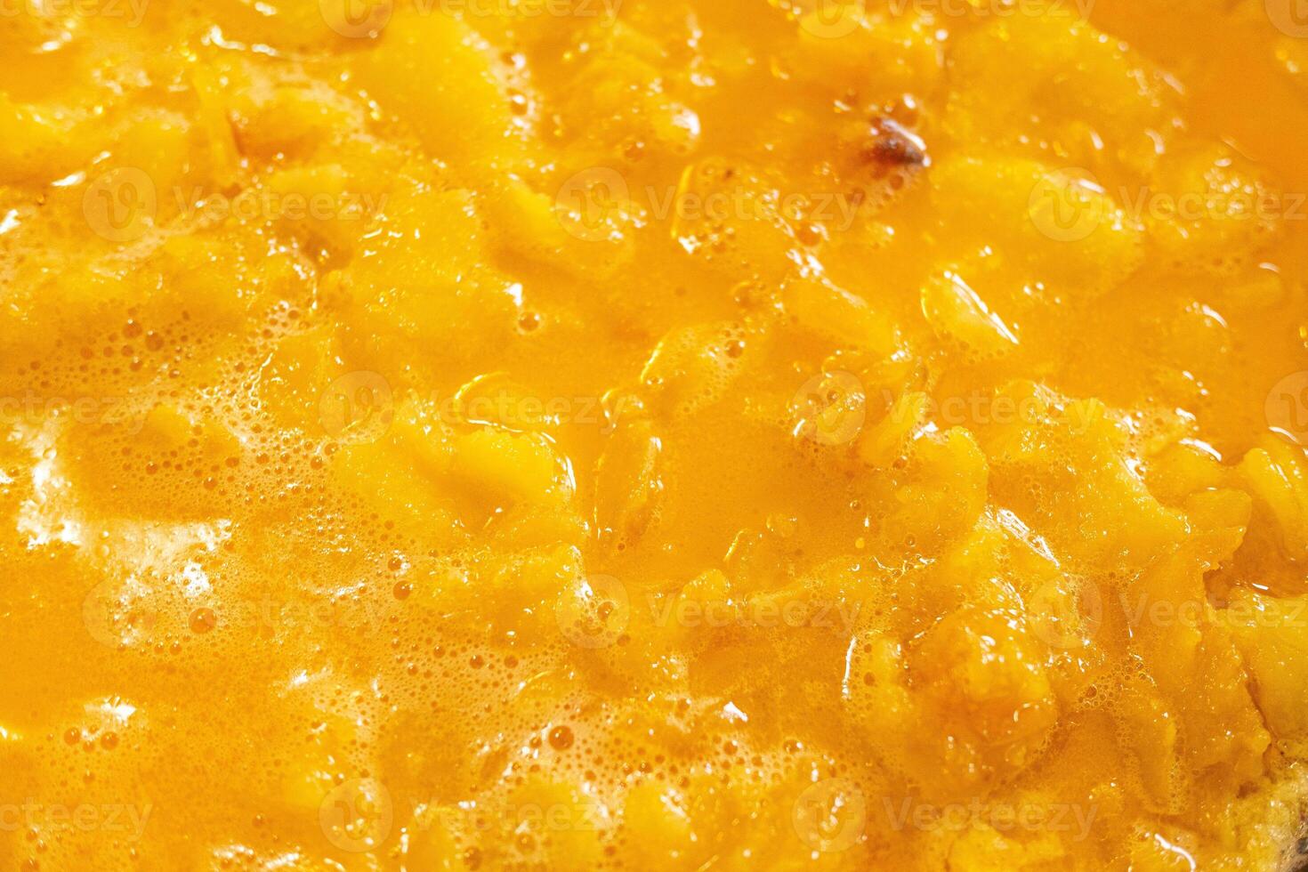 close-up view of a typical Spanish potato omelet, cooking in the frying pan photo