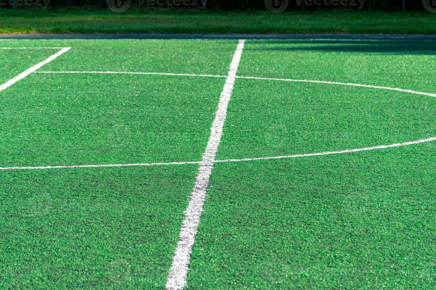 detail of the center line in a synthetic grass surface of a football field photo