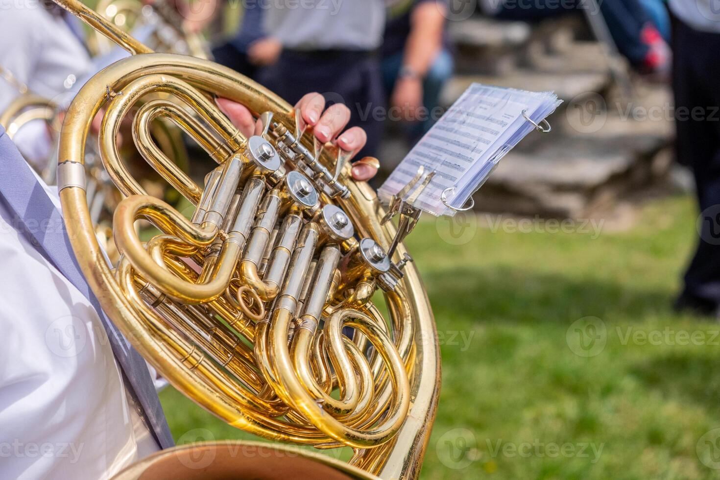 a musician playing the horn in a marching band at an outdoor concert photo