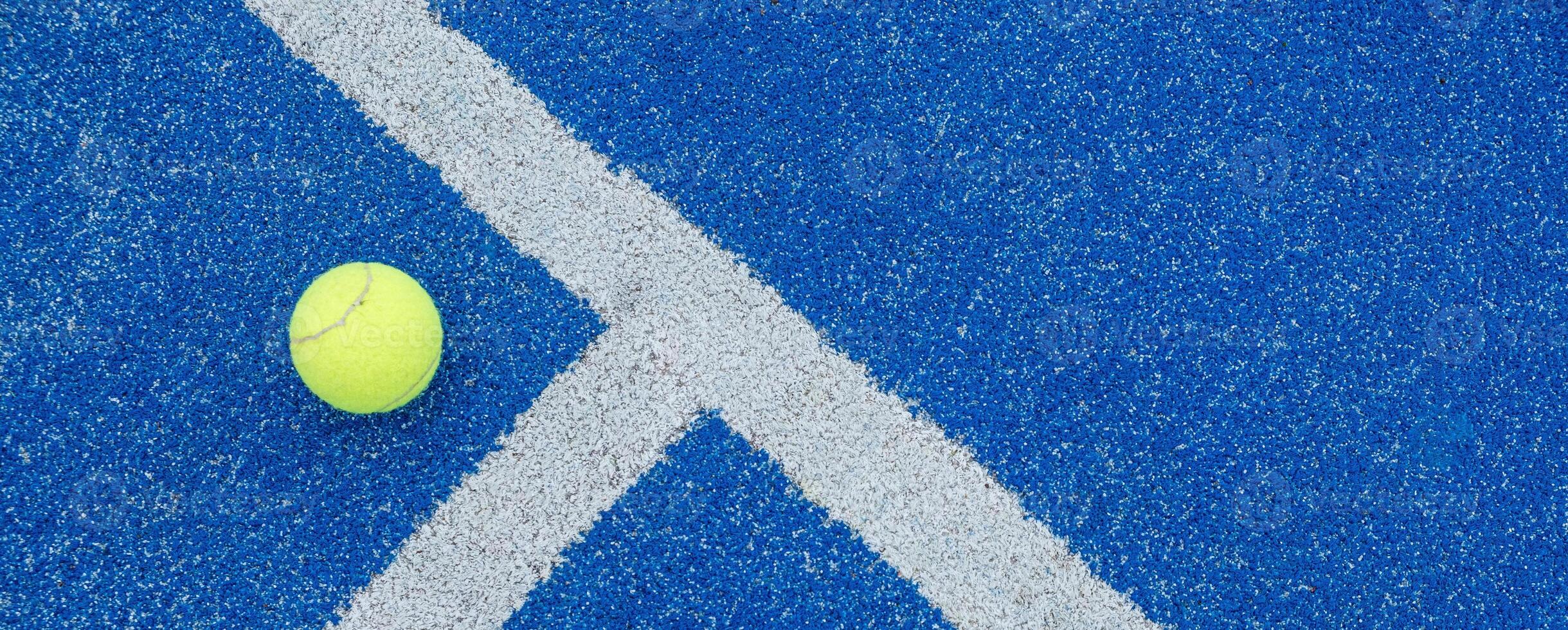 ball on a blue turf court paddle tennis court photo