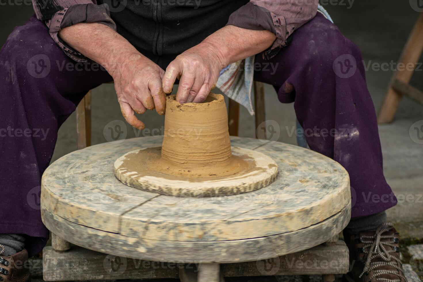 hands of a potter working the ceramic clay, traditional works concept photo