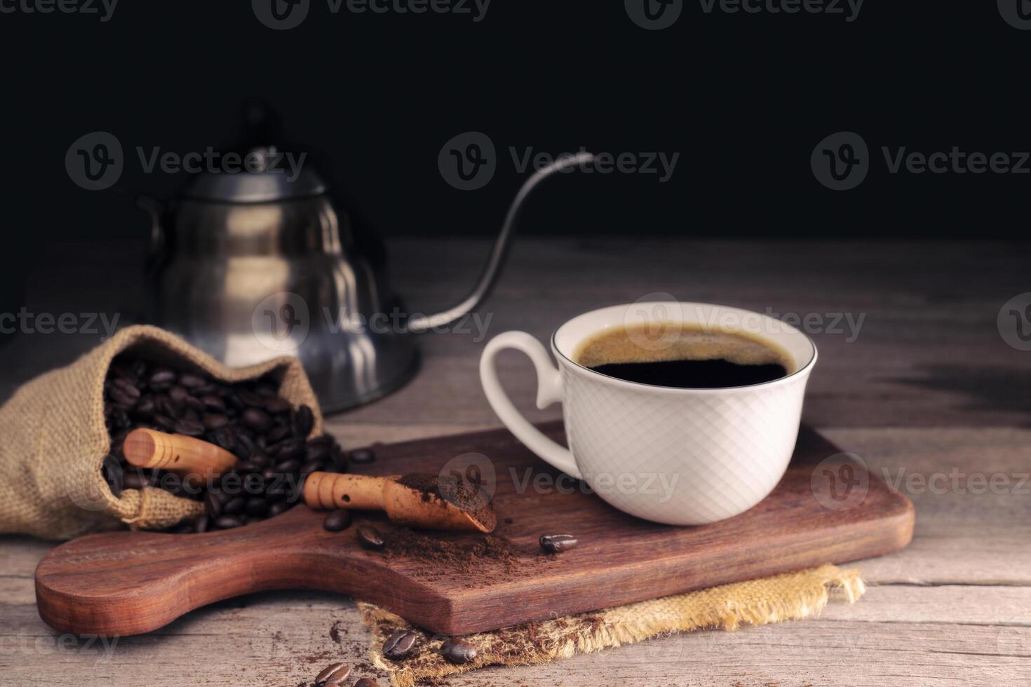 Black coffee with white cup and roasted coffee beans brown sugar and a cup of hot espresso coffee flat top view on a dark background photo