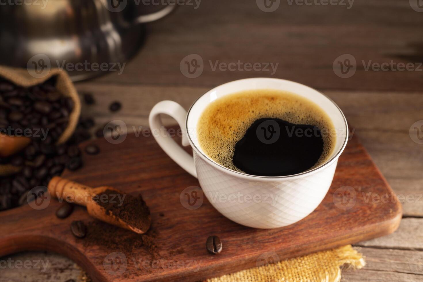 Black coffee with white cup and roasted coffee beans brown sugar and a cup of hot espresso coffee flat top view on a dark background photo