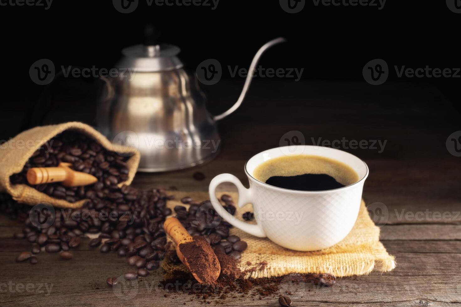 Black coffee with white cup and roasted coffee beans brown sugar and a cup of hot espresso coffee flat top view on a dark background photo