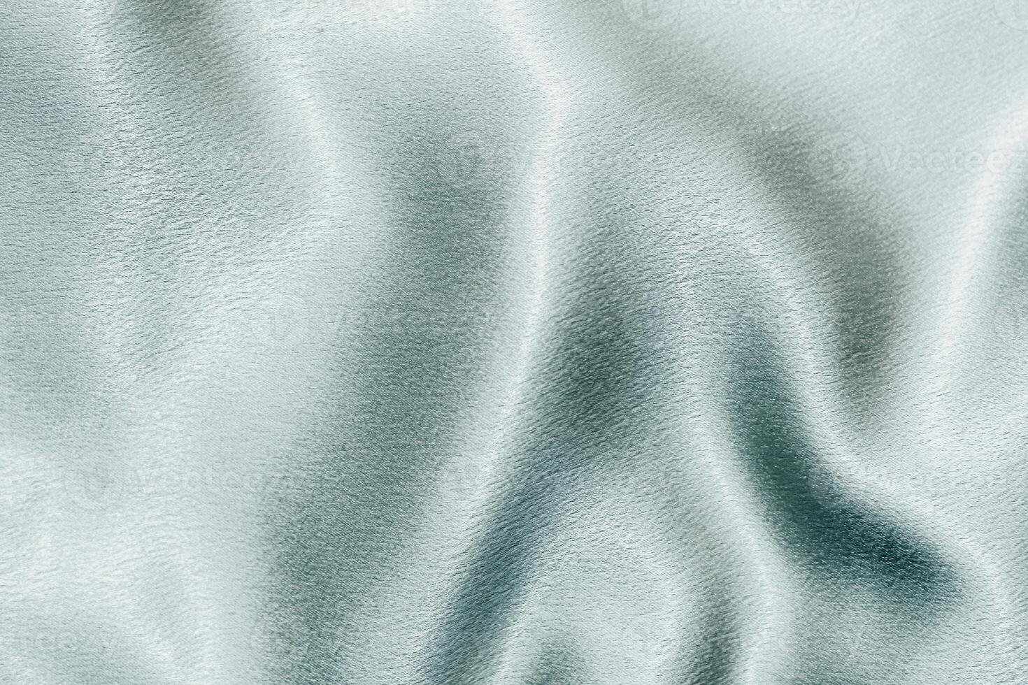 Blue shiny texture of silk satin satin with folds. photo