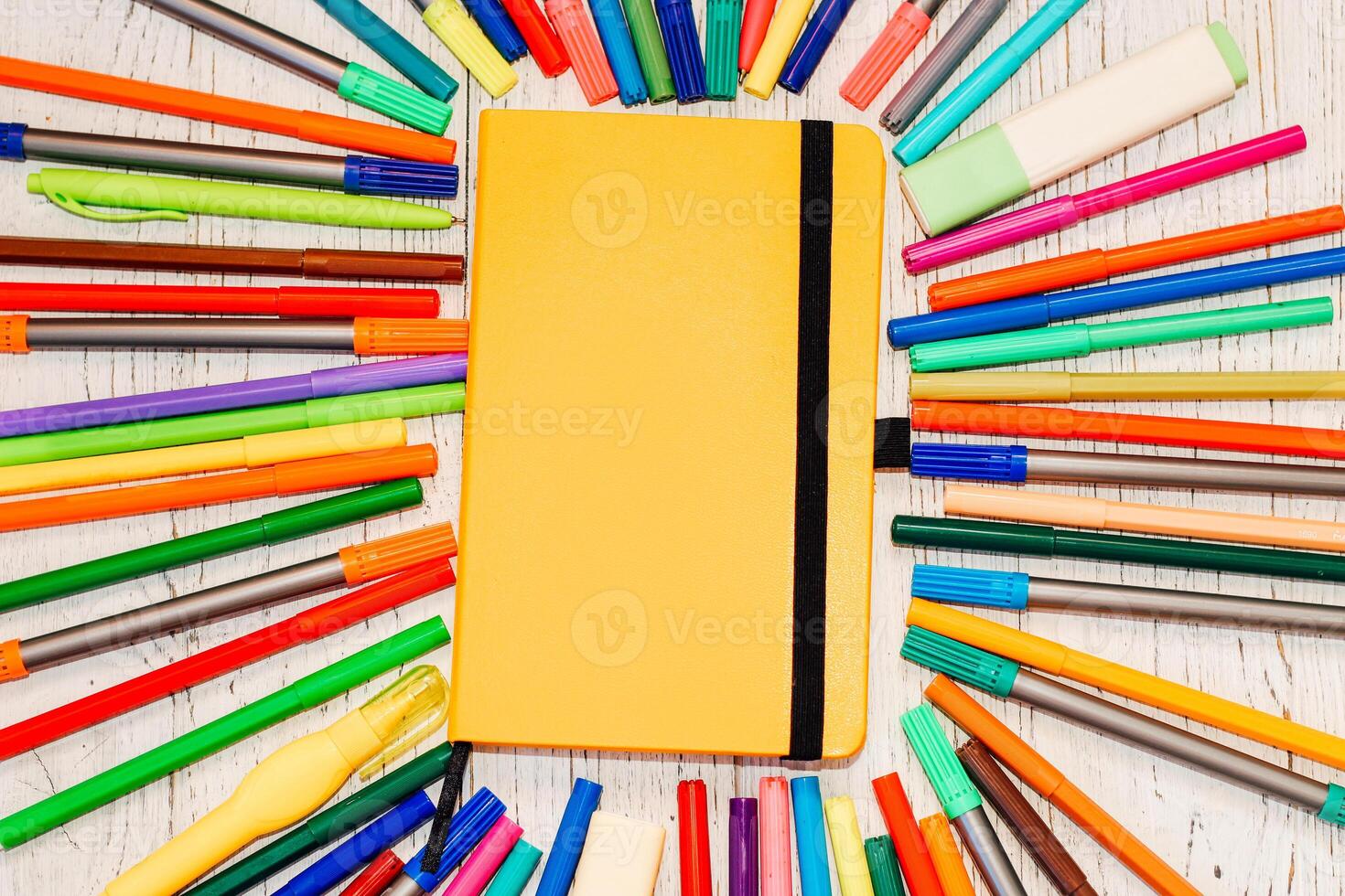 Stationery, colored felt-tip pens on a white table. photo