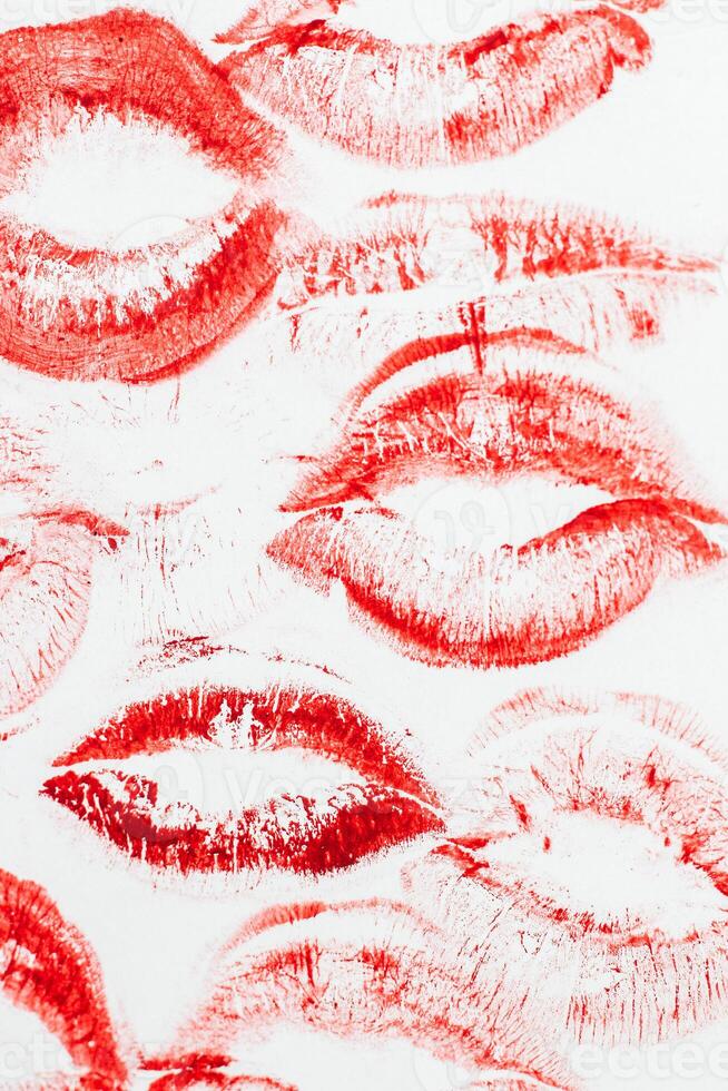 Imprint of red lips on white paper, kiss background photo