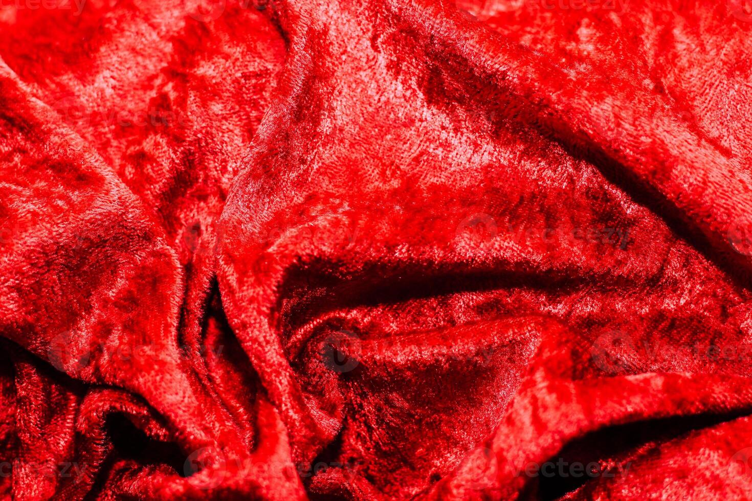 Texture of red velor corduroy fabric with folds photo