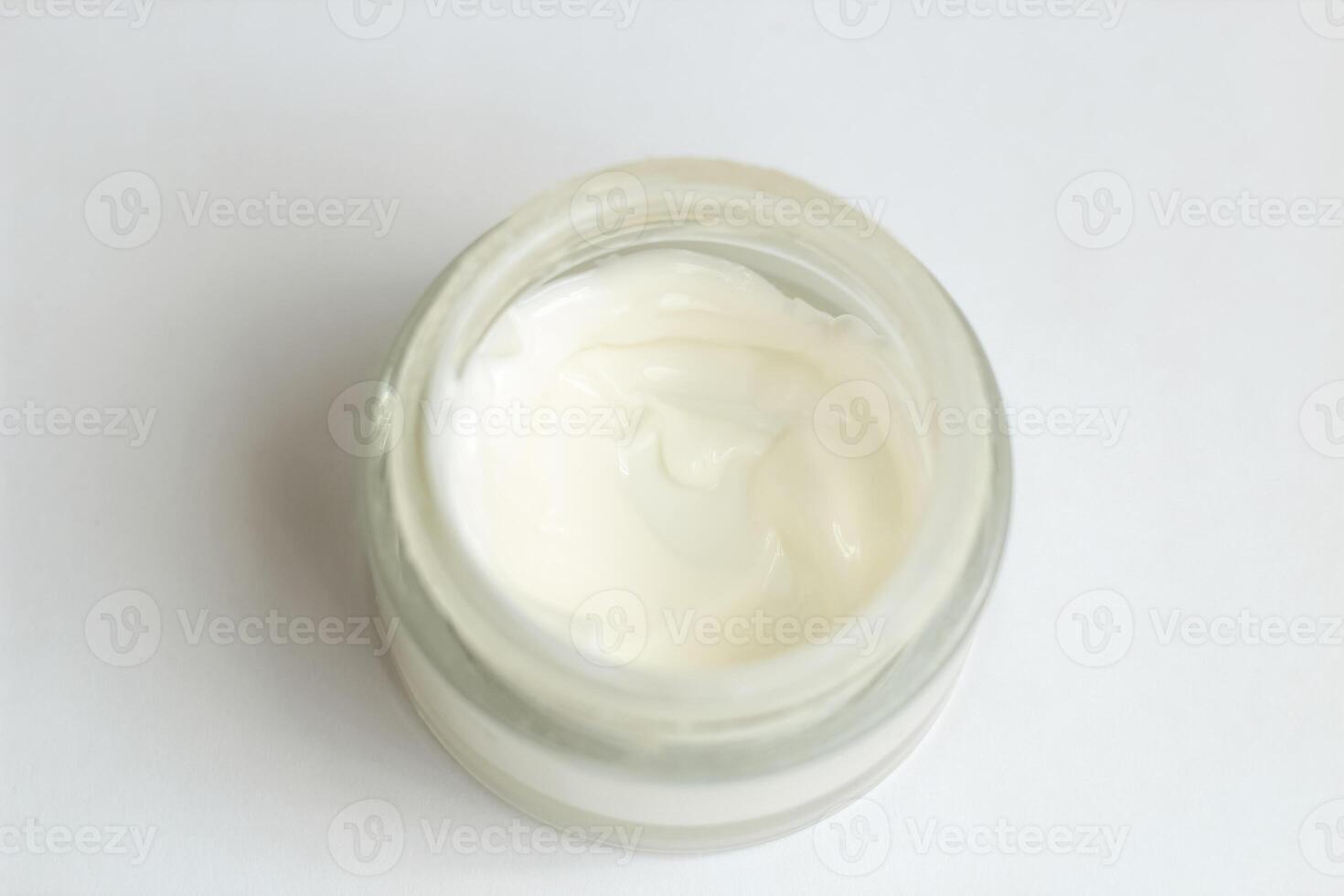 Moisturizing spf cream in a jar on a light background. photo