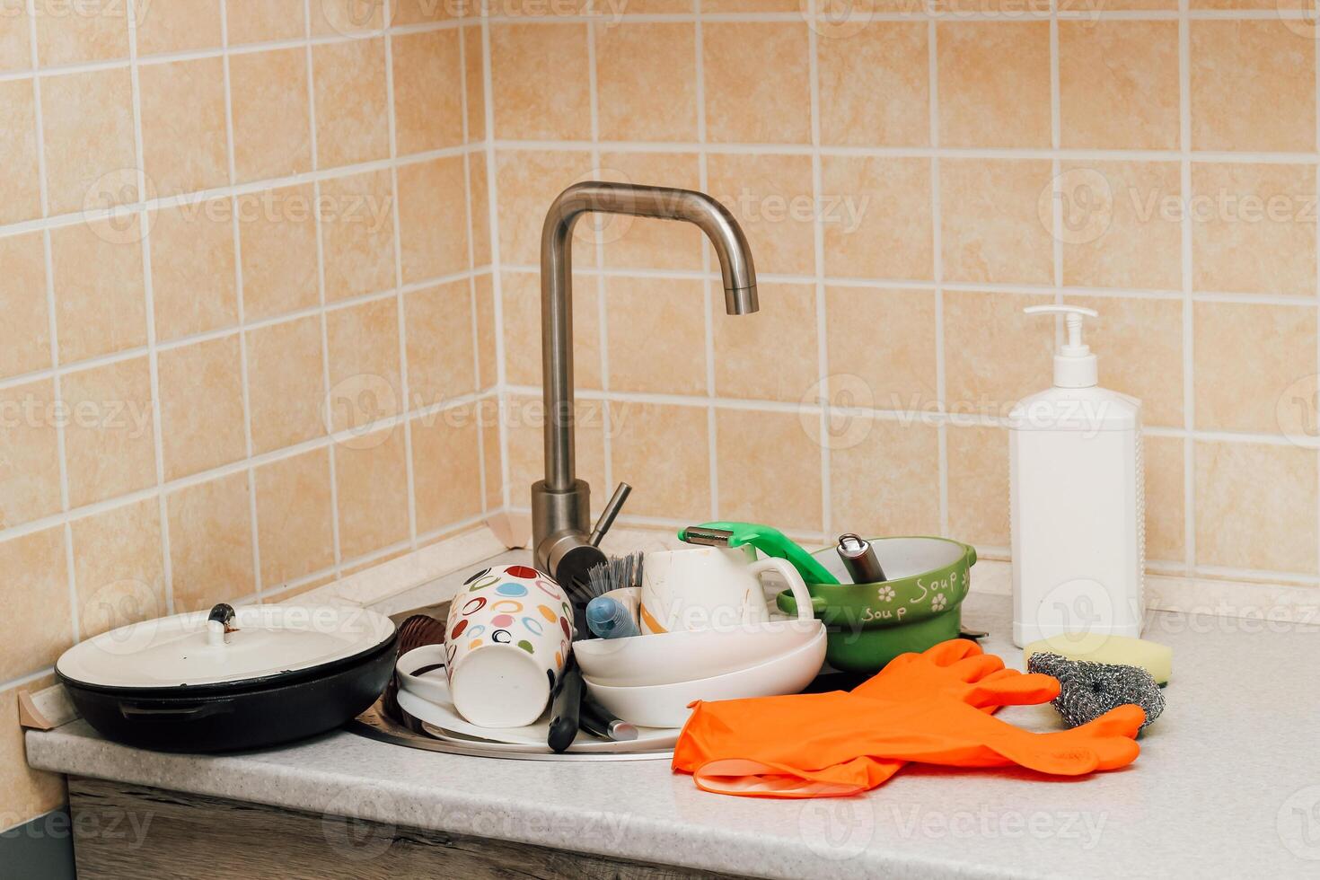 A pile of dirty dishes, cups, plates in the sink. photo