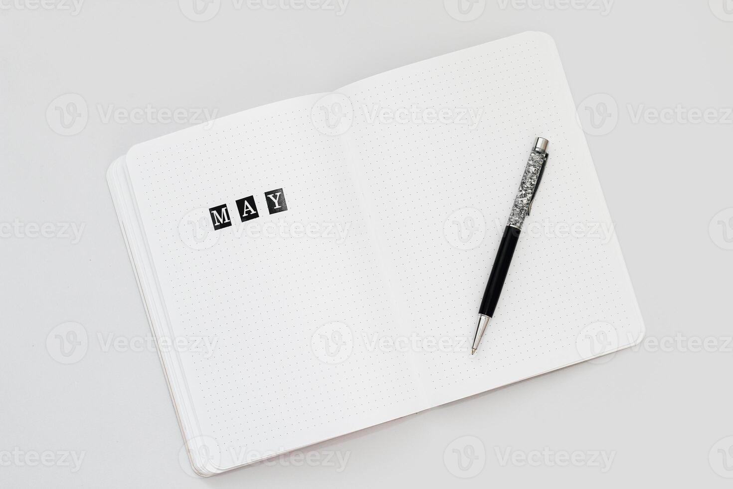 Filling in the diary, the inscription May in the notebook in a dot photo