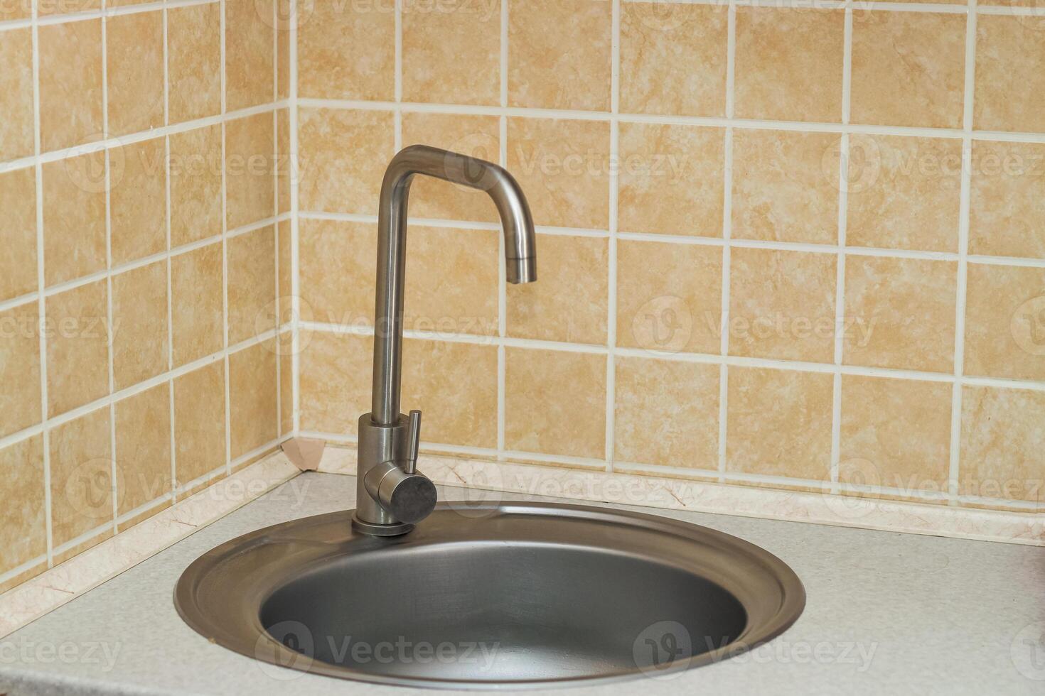 A sink with a faucet in the kitchen. photo