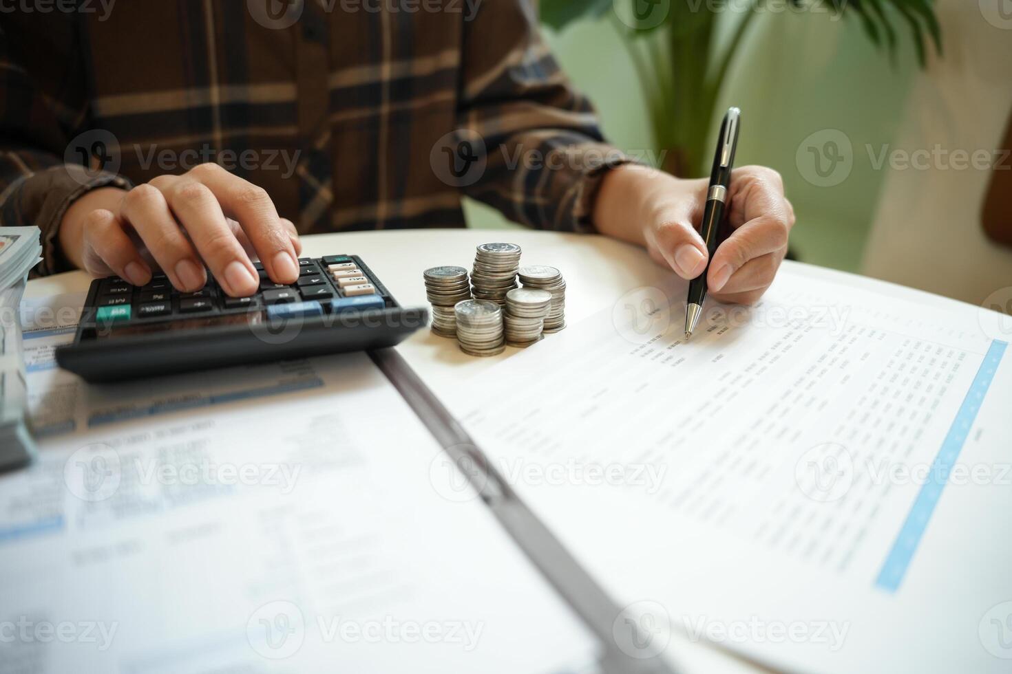 Saving money. Businessman Accountant verify growing business and saving money stacking coins with calculator. Accountancy Concept photo