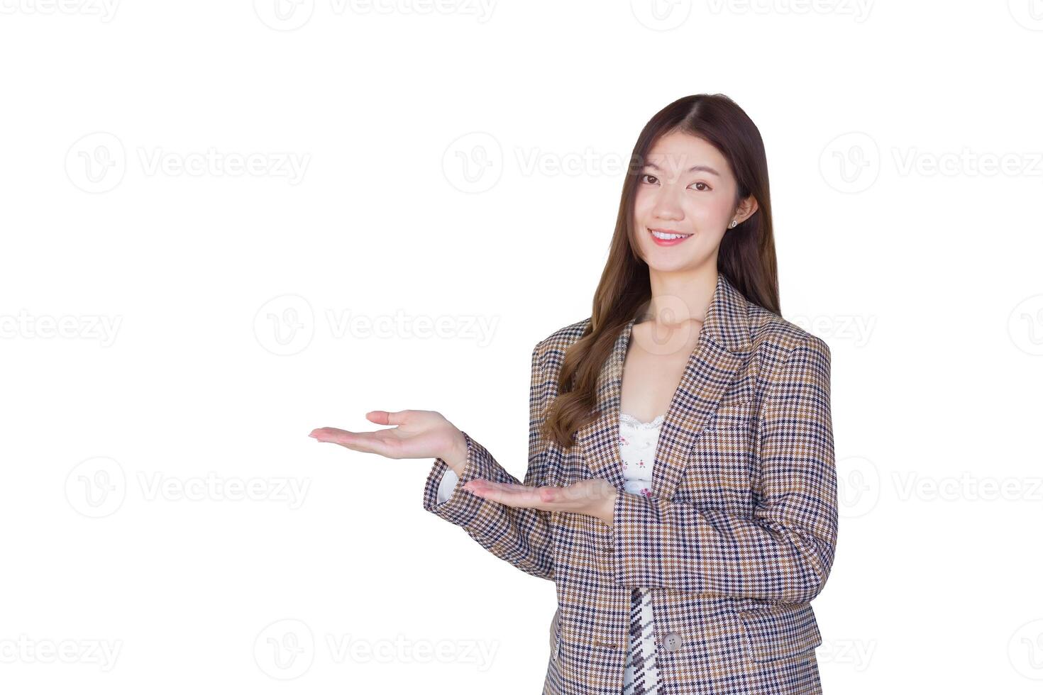 Asian professional female with black long hair wearing a plaid suit and pretty smiling looking at camera is present product while isolated on white background. photo