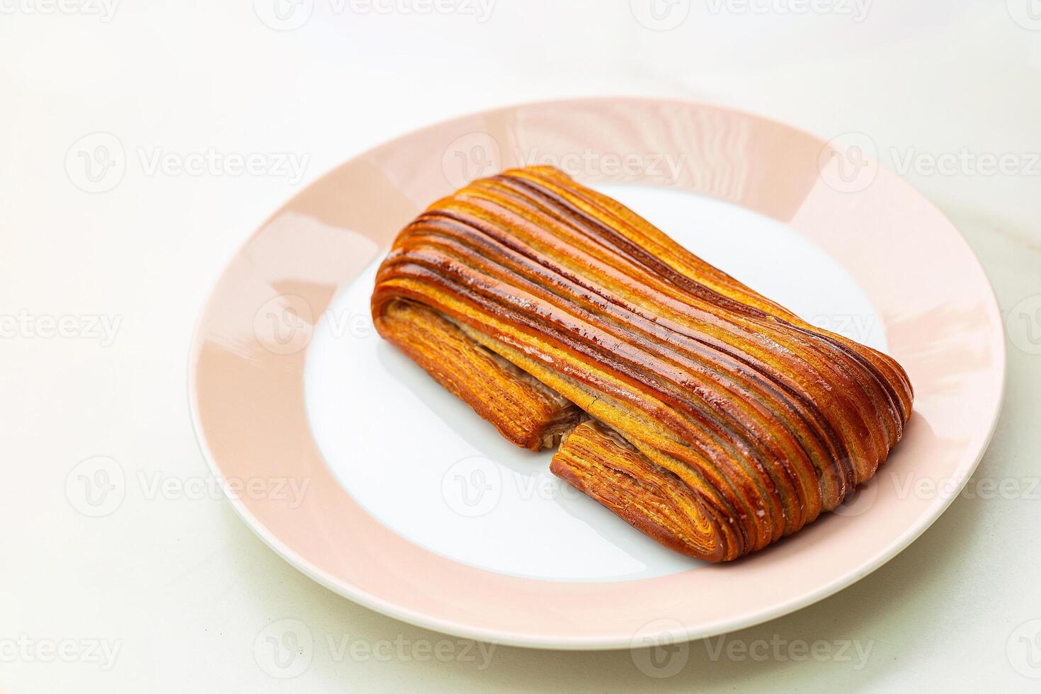 Pain au suisse pasty is a baked pastry suitable for eating with beverages such as tea, coffee, cocoa. It is a delicious breakfast with a crispy exterior in a round dish. photo