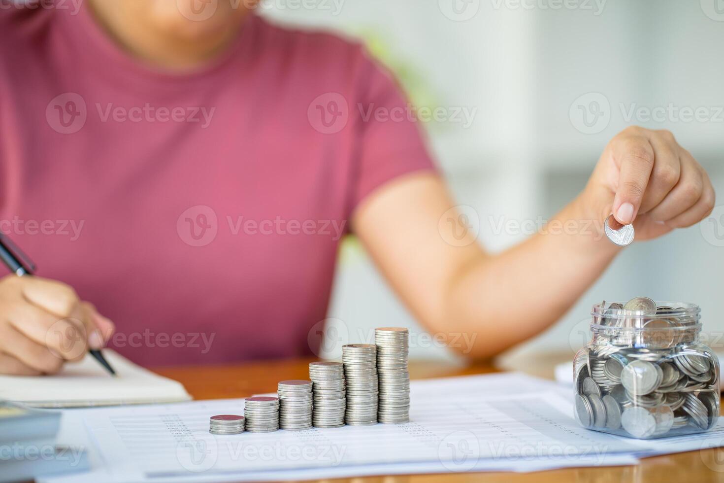 Saving money. Businessman Accountant verify growing business and saving money stacking coins with calculator. Accountancy Concept. photo