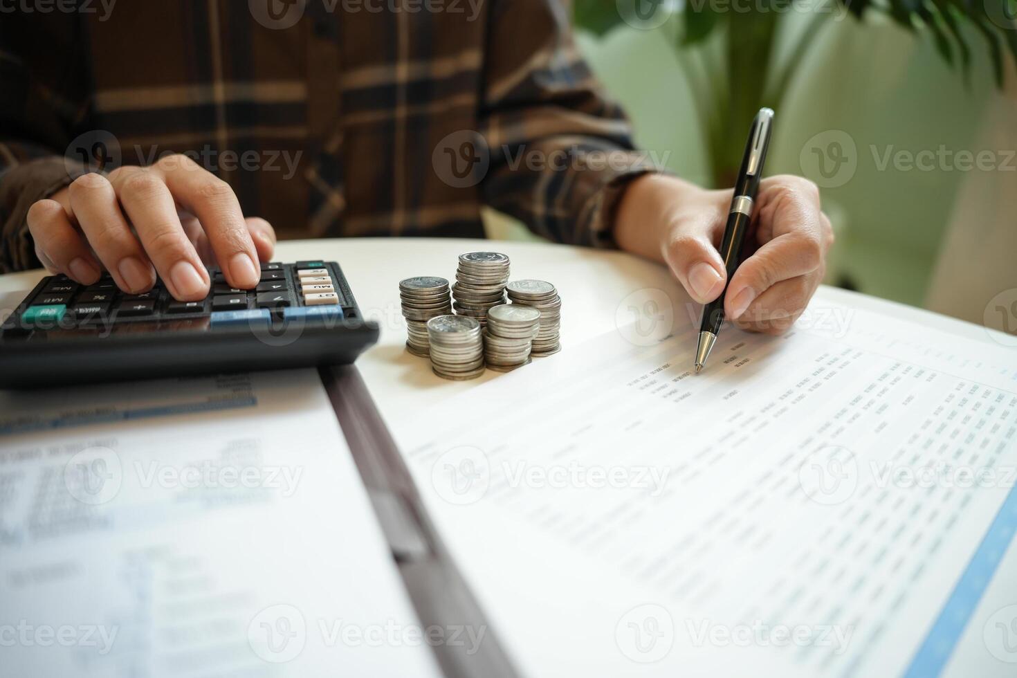 Saving money. Businessman Accountant verify growing business and saving money stacking coins with calculator. Accountancy Concept photo