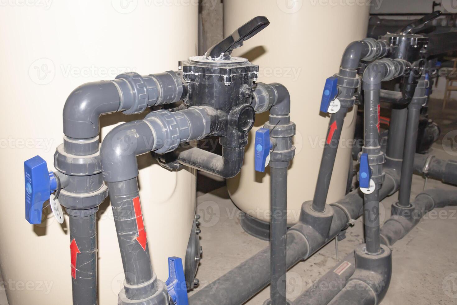A room for dosing chemicals of chlorine and acid when feeding into the pool. Water circulation system in the pumping room. photo