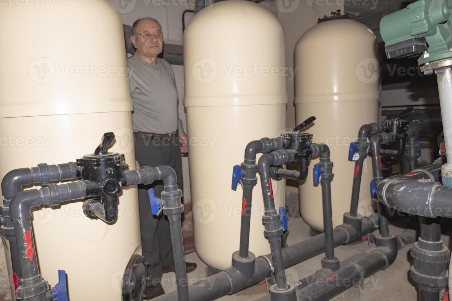 A room for dosing chemicals of chlorine and acid when feeding into the pool. Water circulation system in the pumping room. photo
