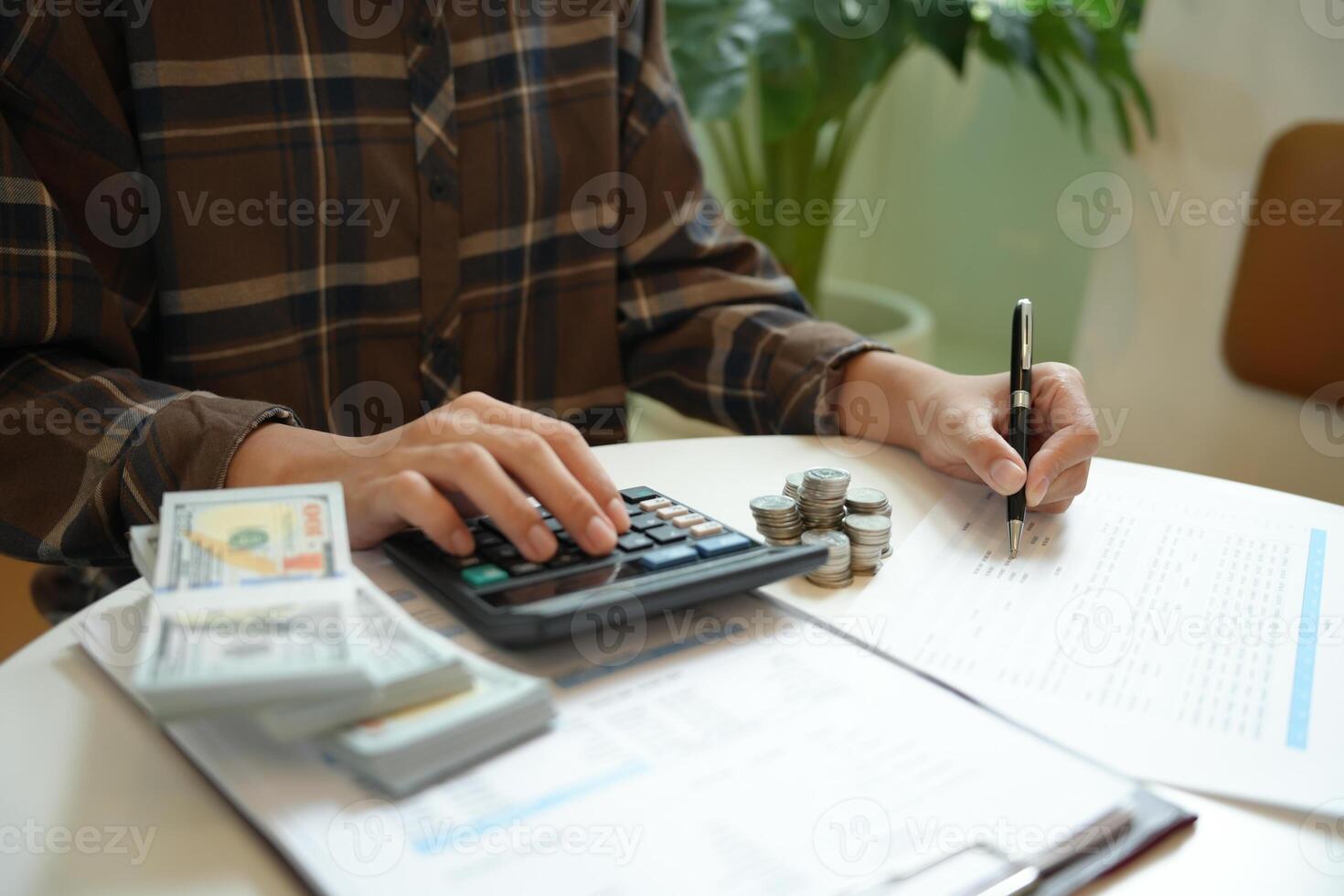 Saving money. Businessman Accountant verify growing business and saving money stacking coins with calculator. Accountancy Concept photo