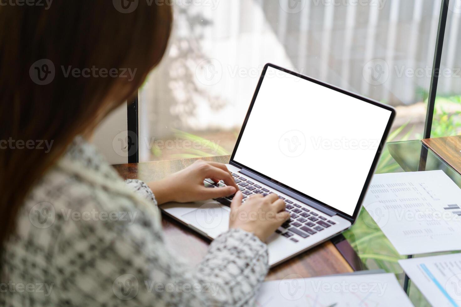 Woman Working by using laptop blank screen computer . Hands typing on a keyboard.technology e-commerce concept photo