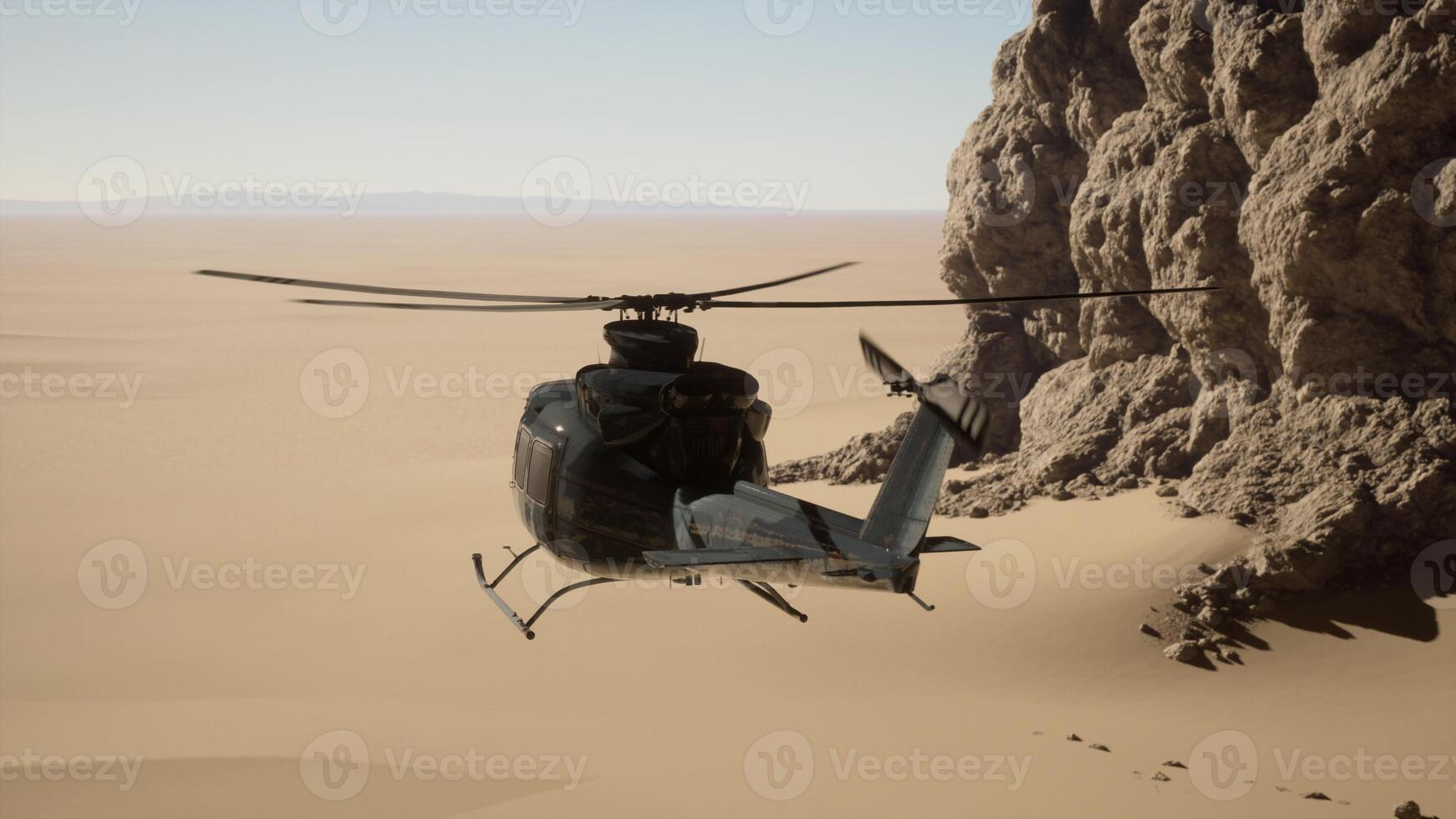 A helicopter flying over a desert with a rock formation in the background photo