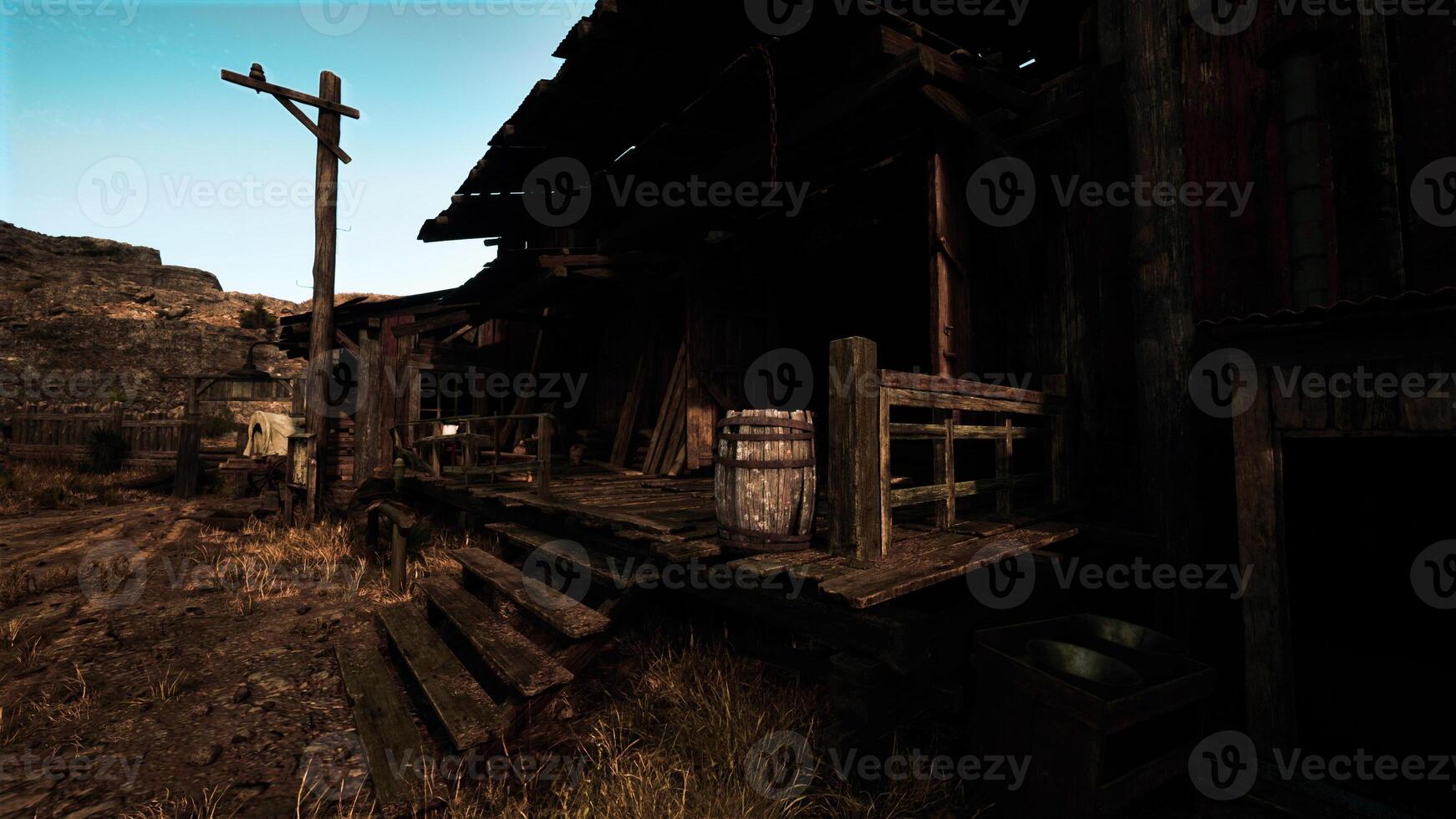 An abandoned wooden building in the midst of a barren desert landscape photo