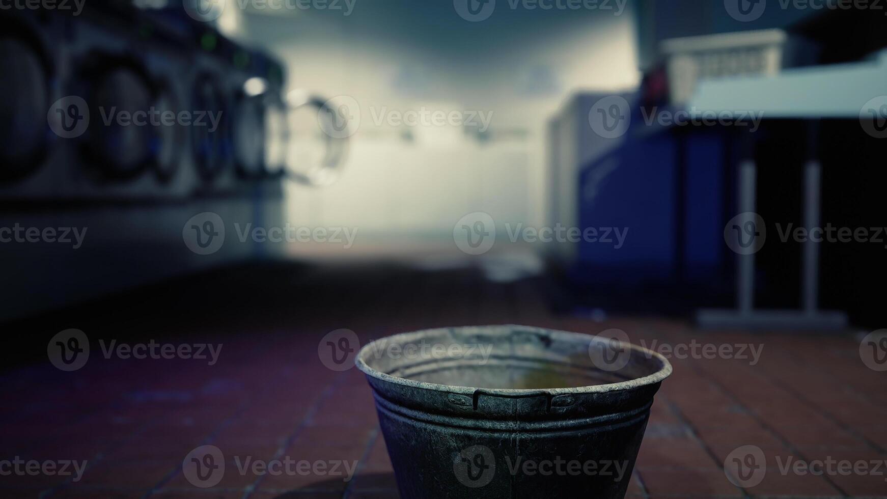 A bucket sitting on the ground in the dark photo