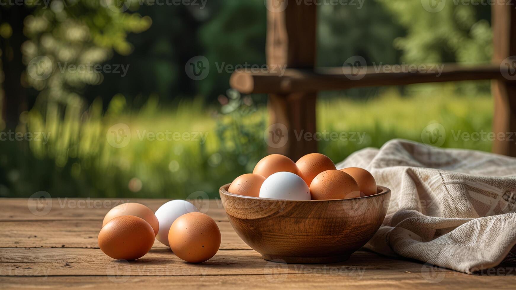 Rustic chicken eggs in a wooden bowl and plate on a wooden surface on rustic countryside blurred background. Banner with copy space. Farm natural products concept. Nature landscape photo