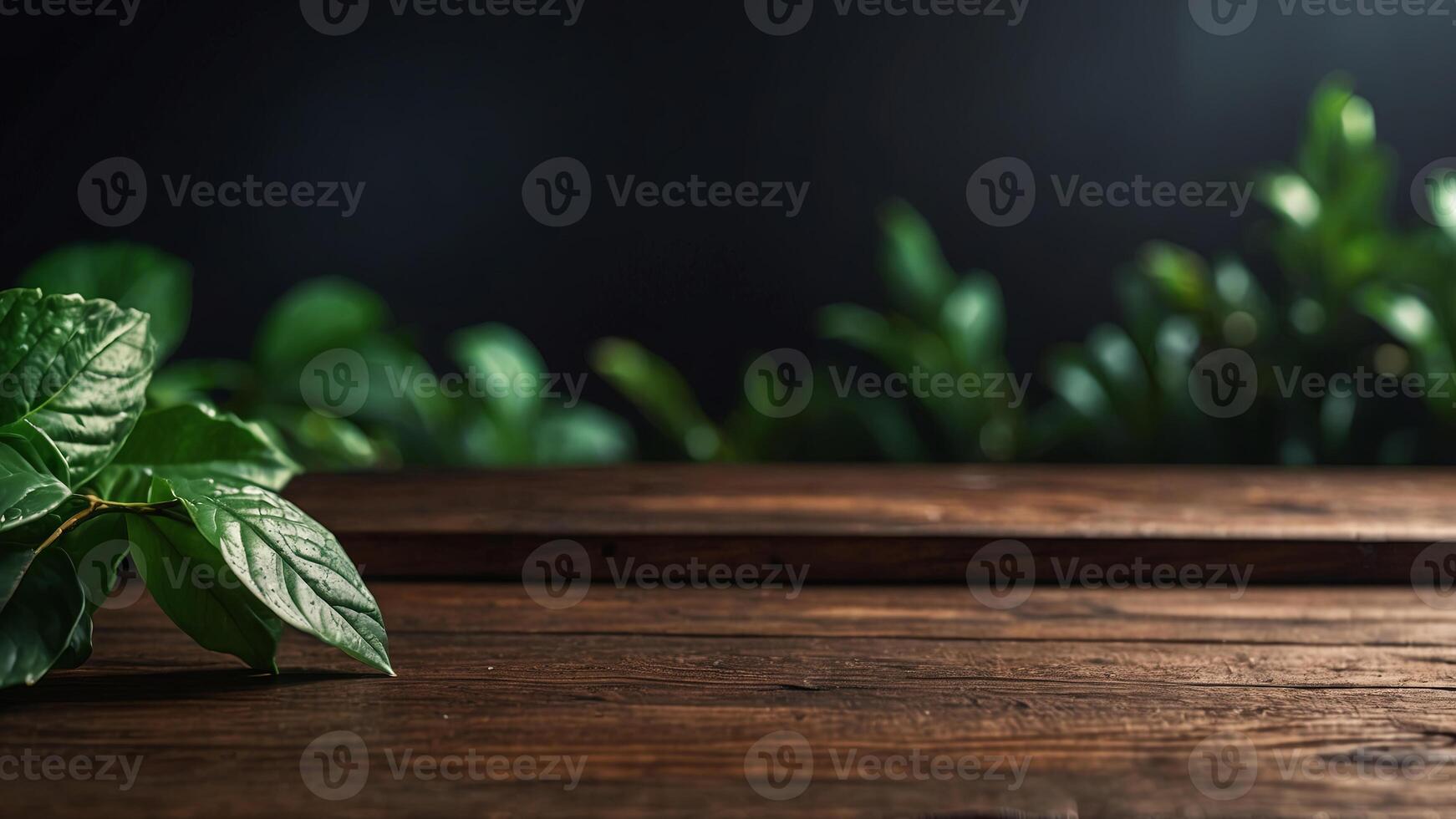 Wooden table top on blurred dark background with green leaves. Banner with copy space. Template showcase scene for display, montage, advertising product. photo