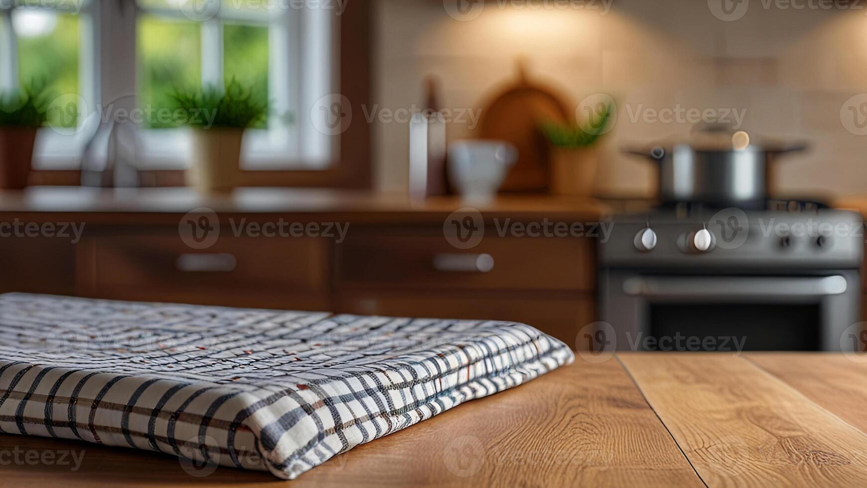 Wooden countertop with tablecloth on blurred modern kitchen interior background. Mock up with copy space. Template showcase scene for display, montage, advertising product photo