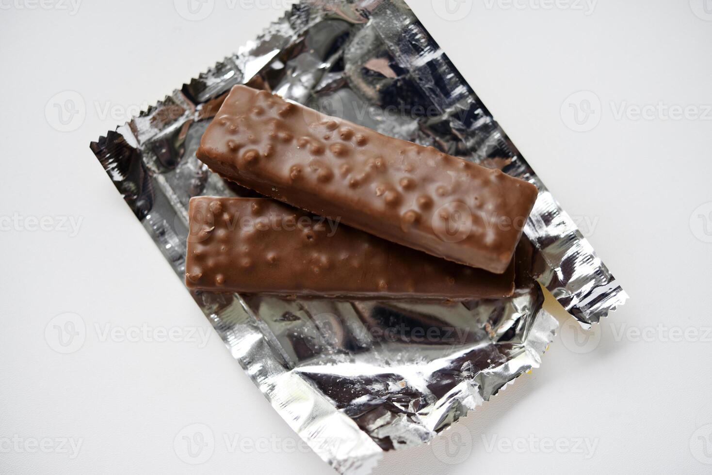 A sweet chocolate bar in a package. A waffle chocolate bar. photo
