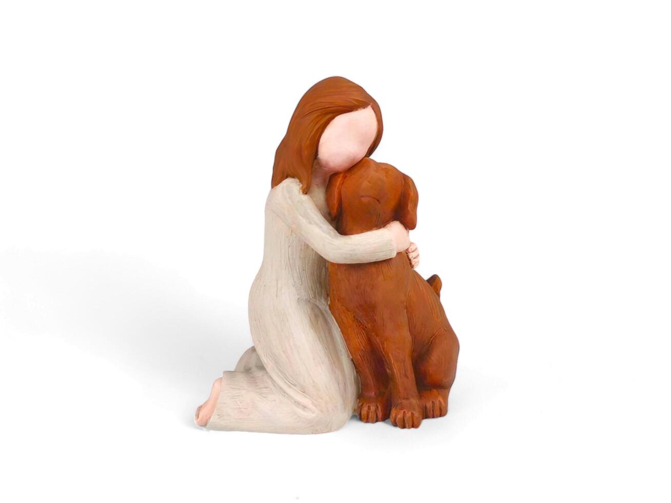 wooden miniature of a woman hugging a dog on a white background photo