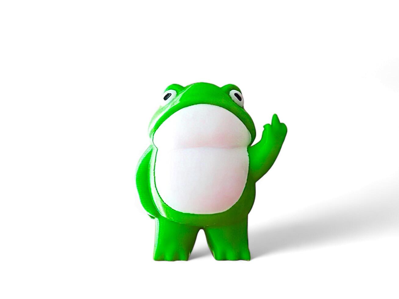 Miniature green frog on a white background photo