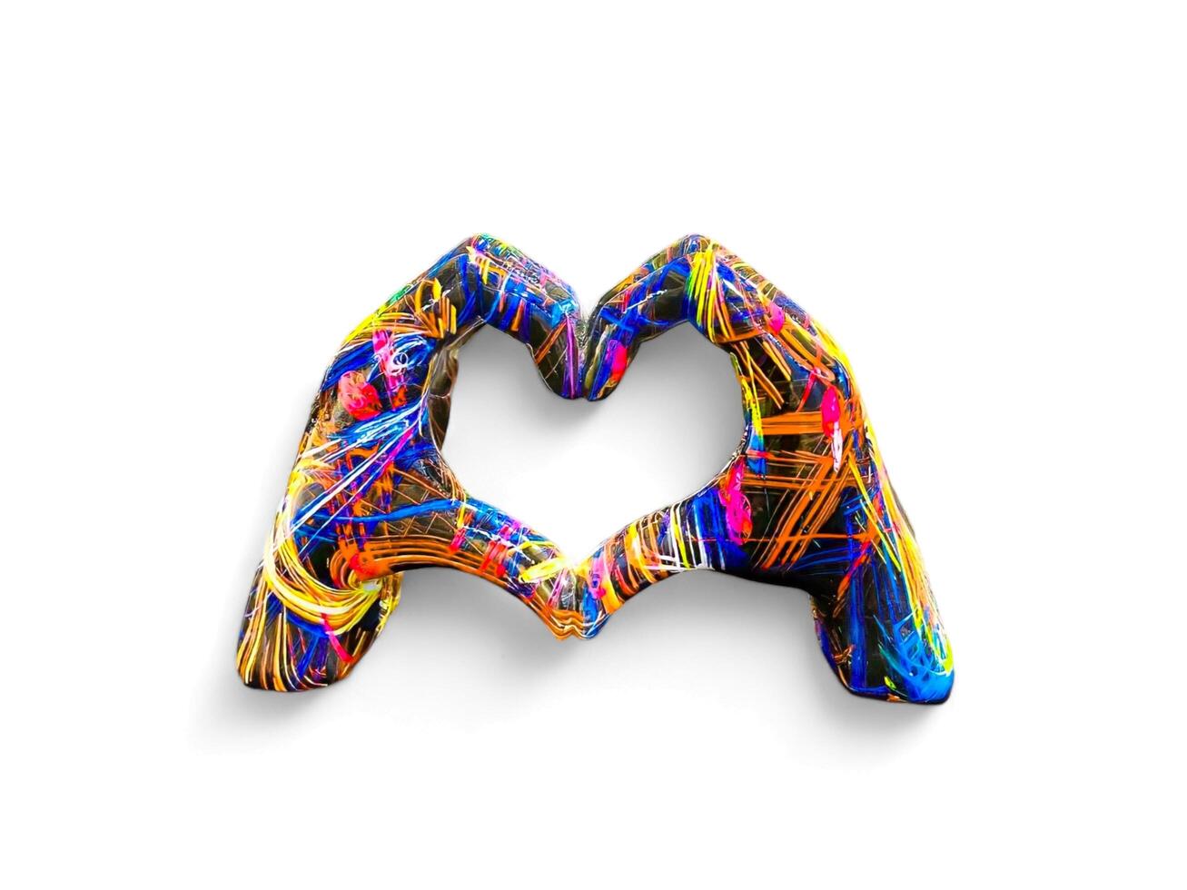 a hand decorated statue that forms a heart symbol photo