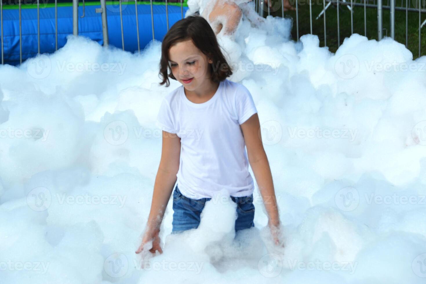 happy girl with foam on her head, in wet clothes at a foam party, in wet clothes at a foam party photo