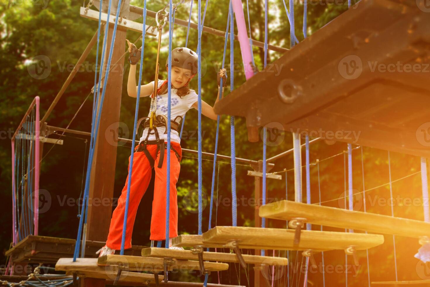 adventure climbing high wire park - people on course in mountain helmet photo