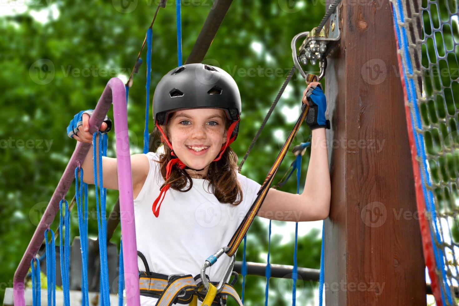 adventure climbing high wire park - people on course in mountain helmet photo