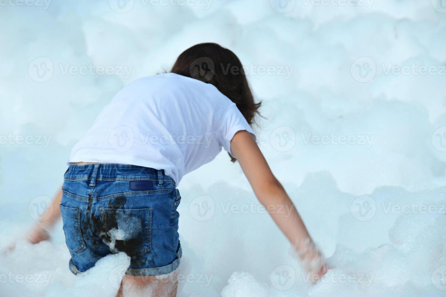 happy girl with foam on her head, in wet clothes at a foam party, in wet clothes at a foam party photo