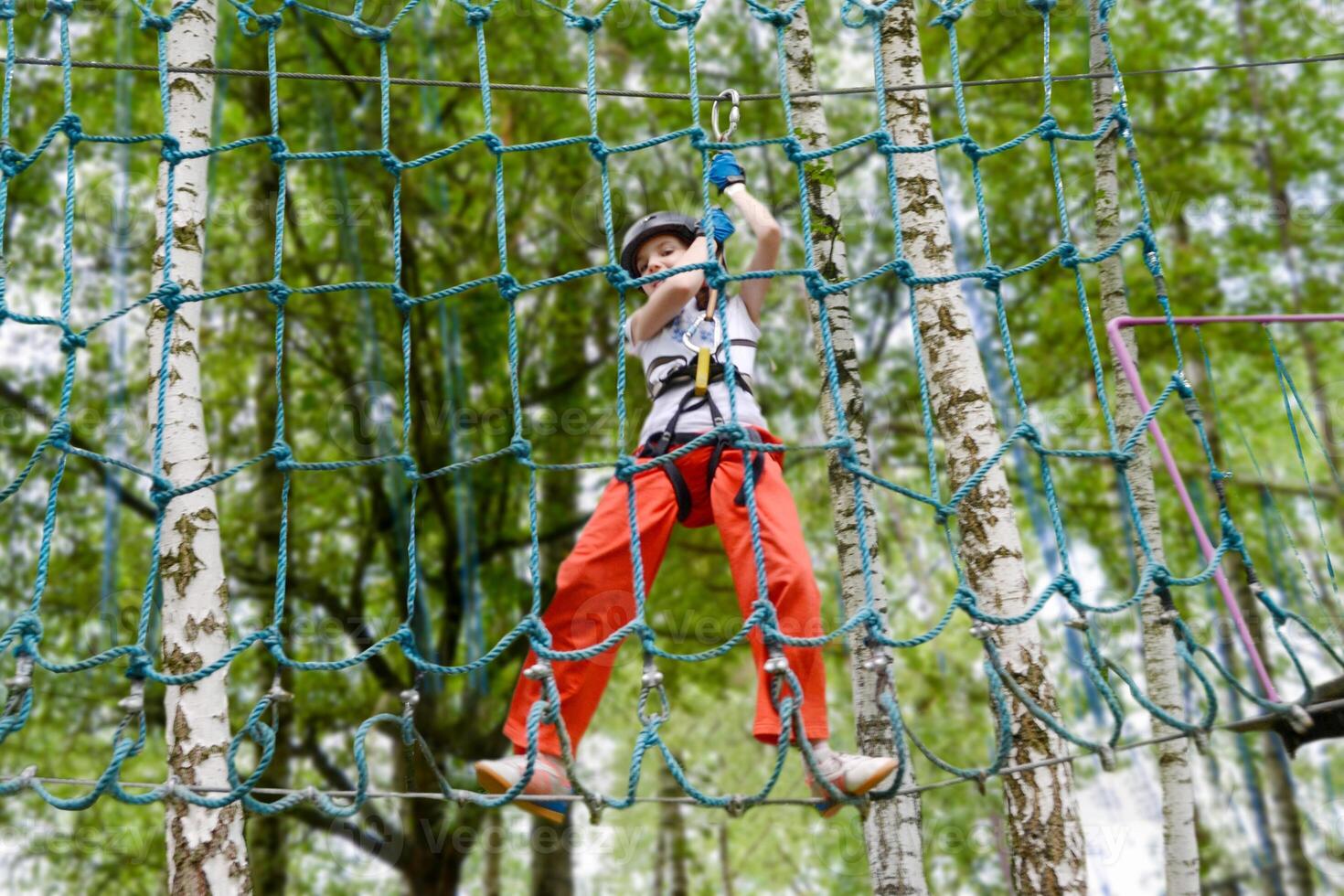adventure climbing high wire park - people on course in mountain helmet photo