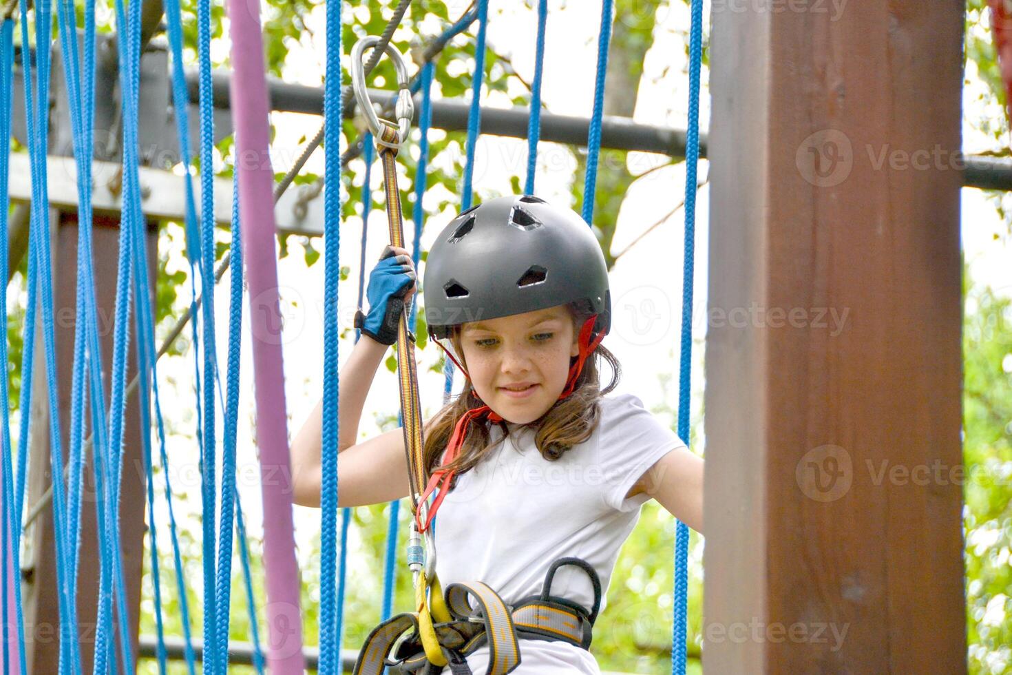 adventure climbing high wire park - people on course in mountain helmet photo