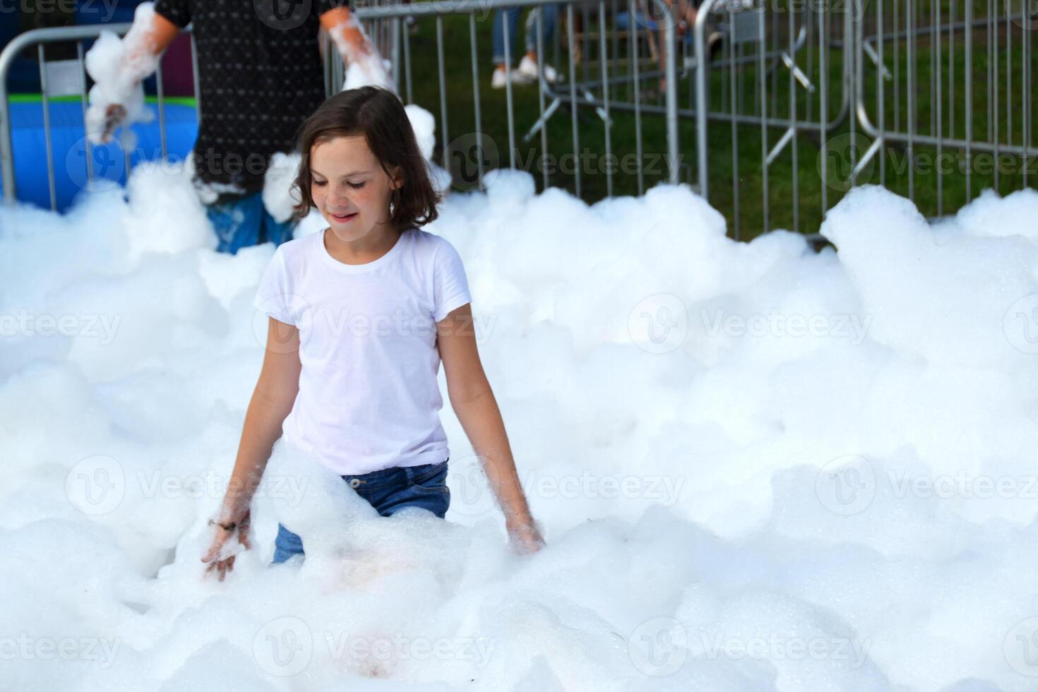 happy girl with foam on her head, in wet clothes at a foam party, in wet clothes at a foam party photo